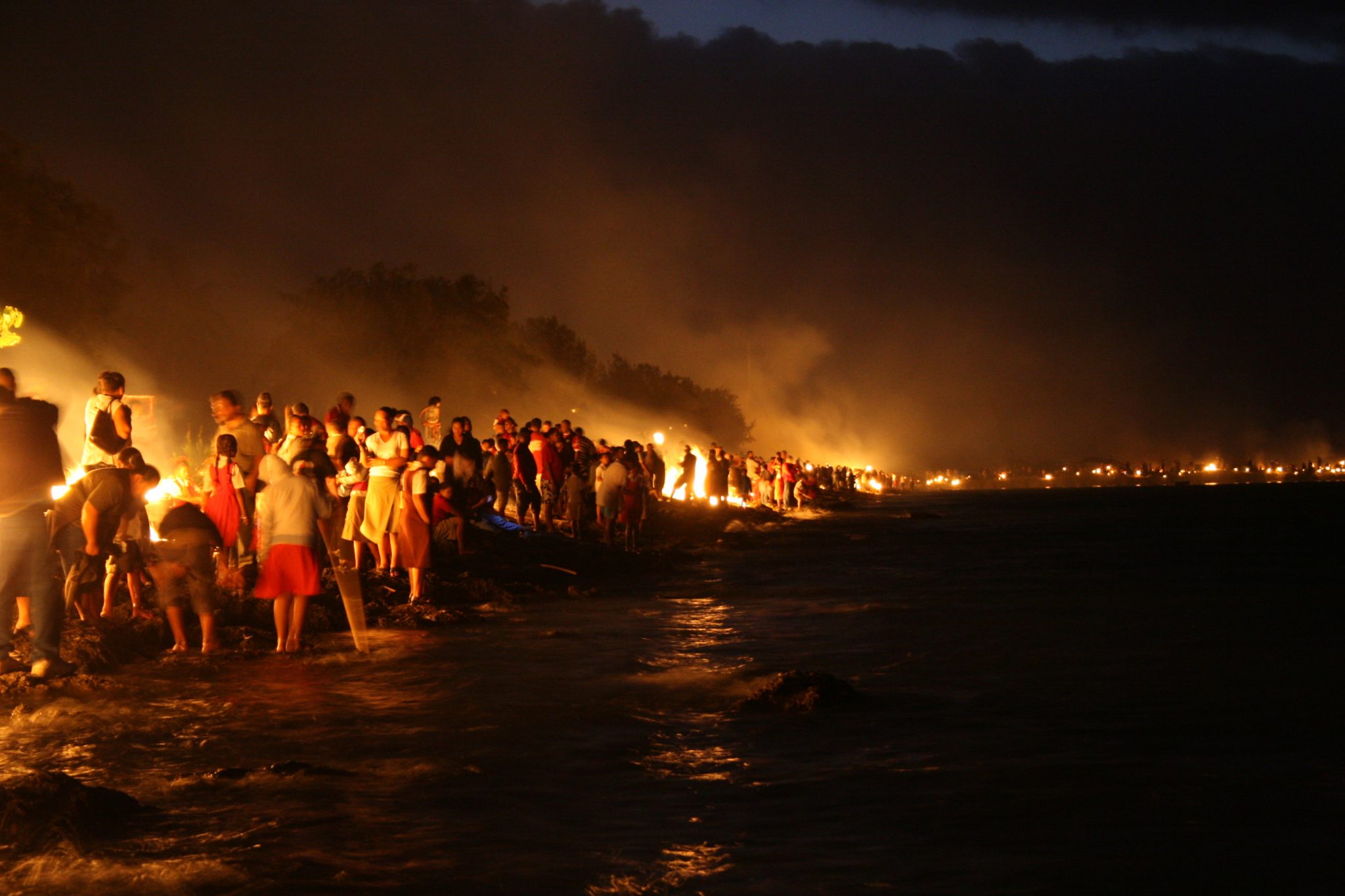 A night fire ceremony beside the sea in Tonga